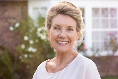 woman smiling with dentures from Central Virginia Family Dentistry