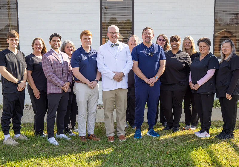 Dr. John Howard and his team standing outside the office of Central VA Family Dentistry.
