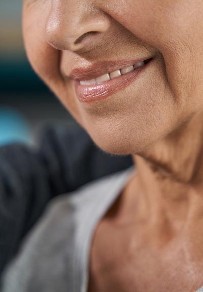 woman smiling with her all-on-4 dental implants from Central Virginia Family Dentistry