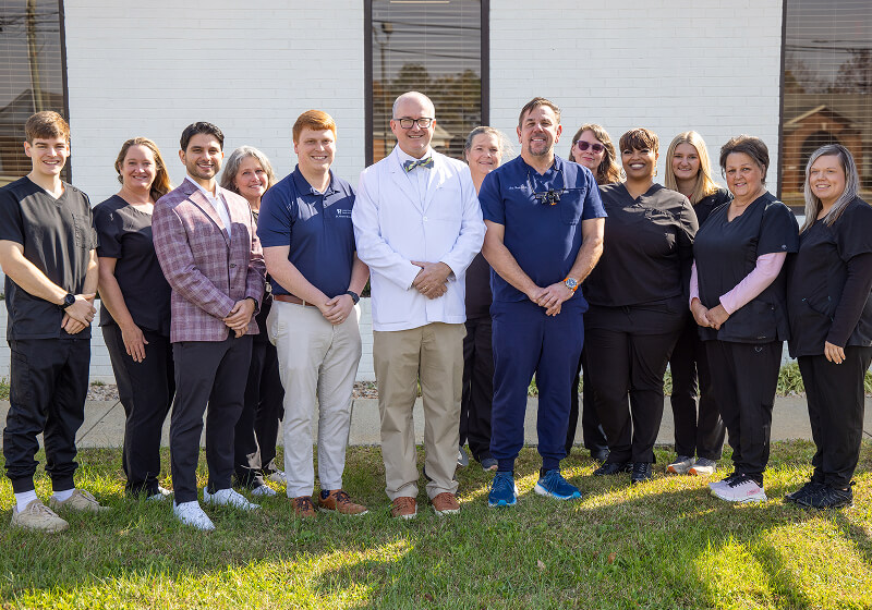 Dr. John Howard and his team standing outside the office of Central VA Family Dentistry. 