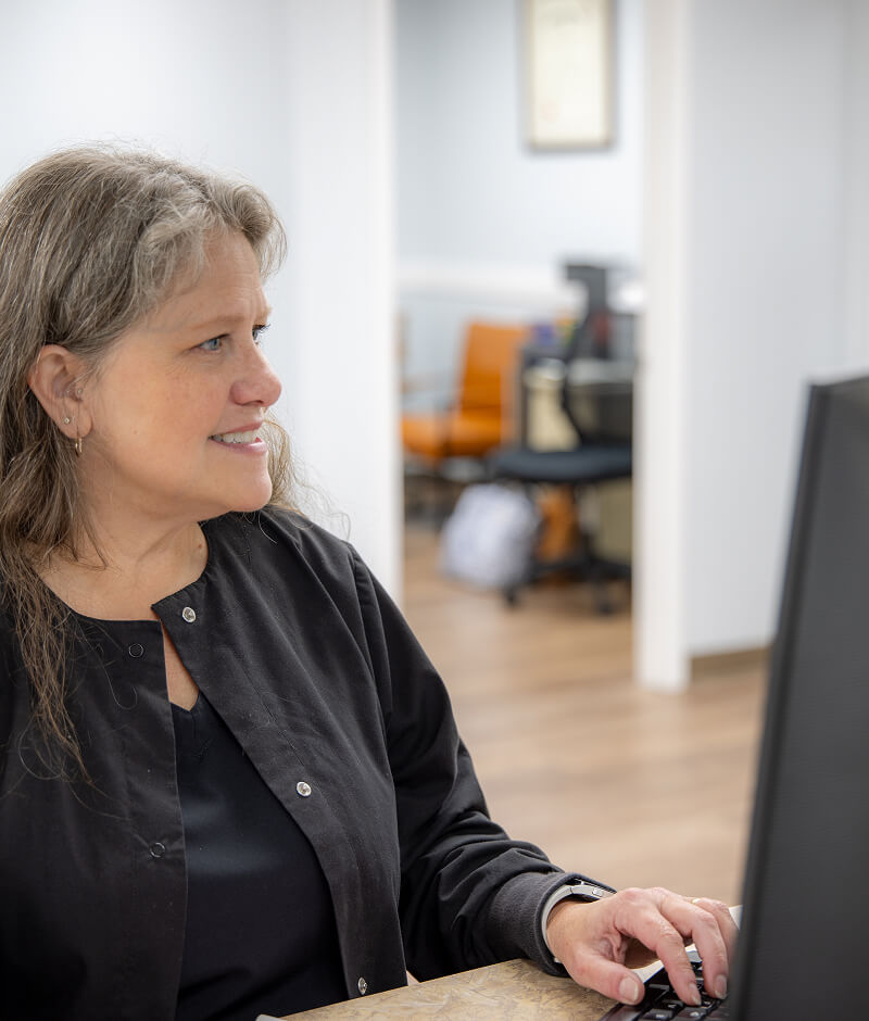 Staff member at a computer in Central Family Dentistry in Lynchburg VA.
